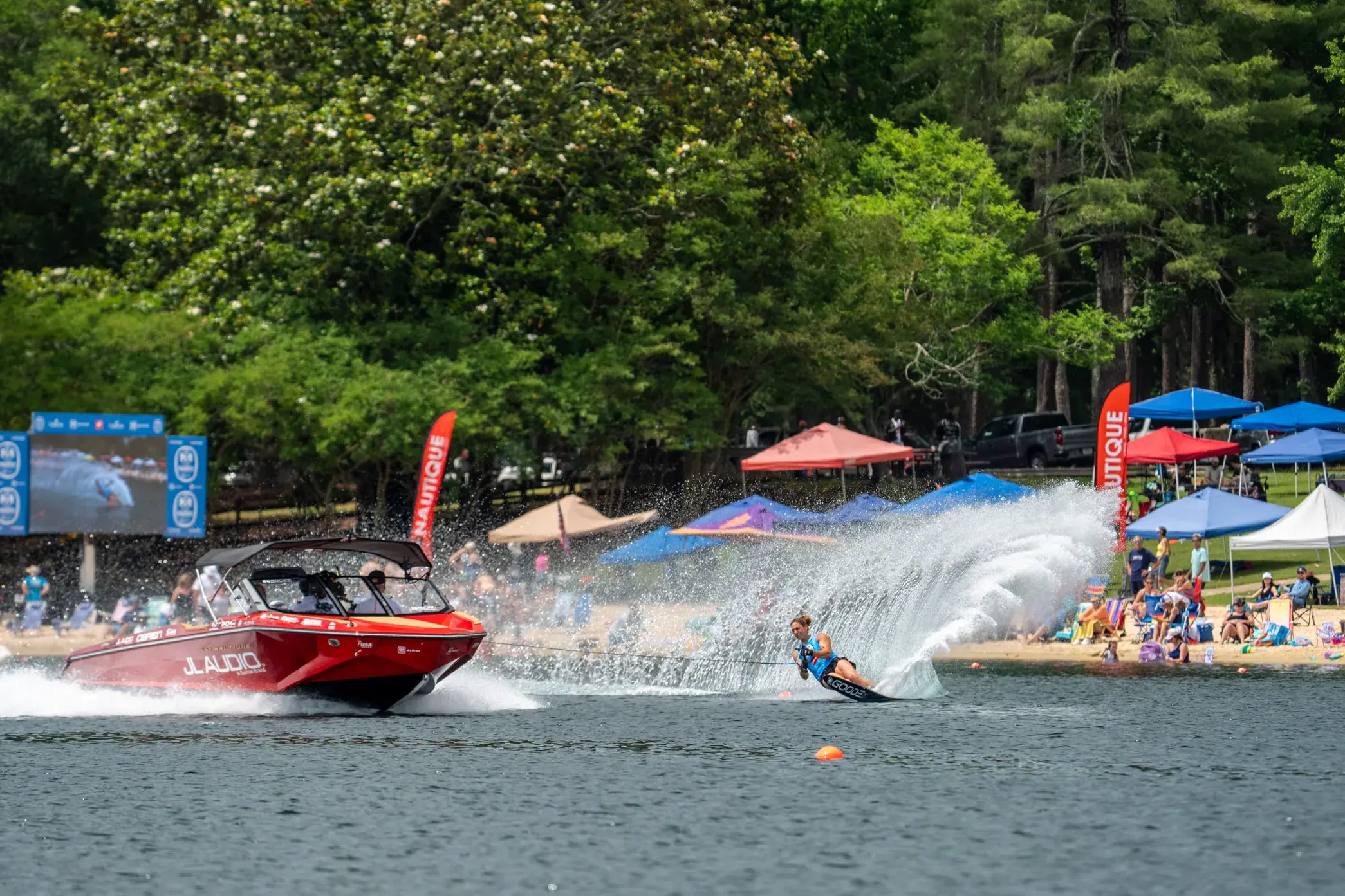 A ski boat running early on glass water